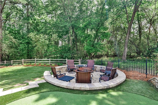 view of yard with a fenced backyard, a patio, and an outdoor fire pit