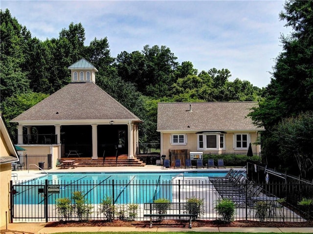 pool featuring a patio and fence