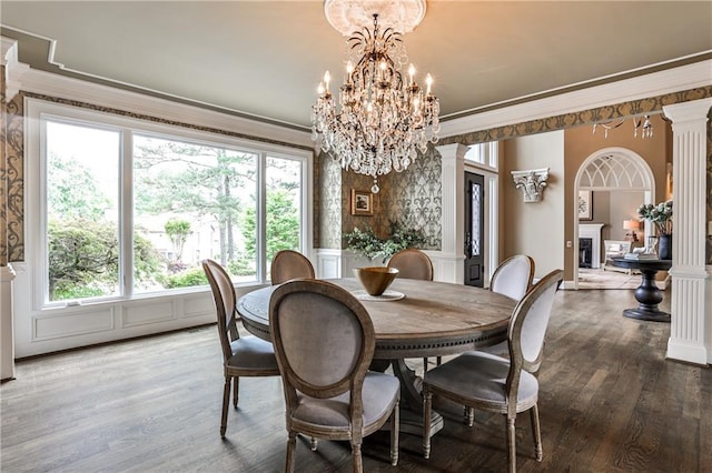 dining area featuring crown molding, a healthy amount of sunlight, and wood finished floors