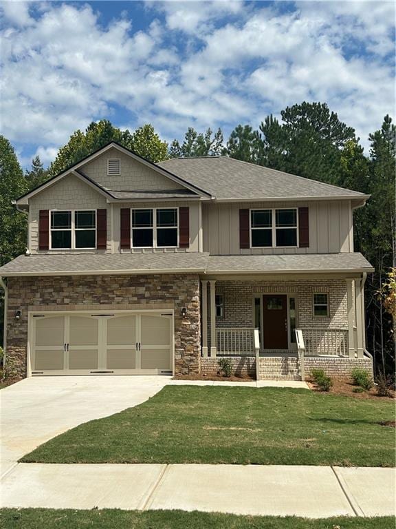 craftsman-style home with a front yard, a garage, and a porch