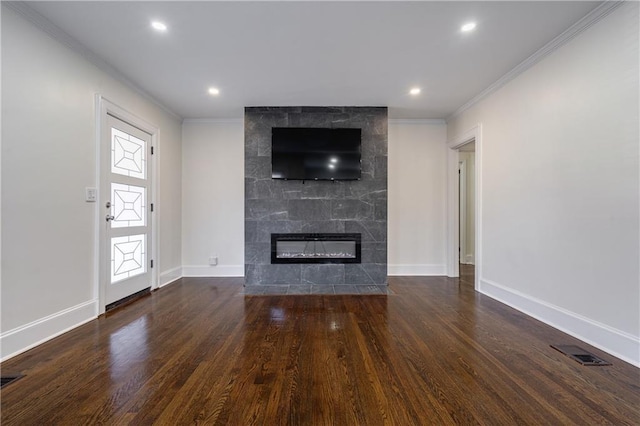 unfurnished living room with ornamental molding, wood finished floors, visible vents, and a tile fireplace