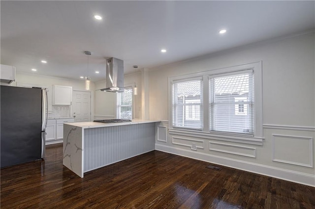 kitchen featuring stainless steel appliances, dark wood-style floors, island range hood, and white cabinetry