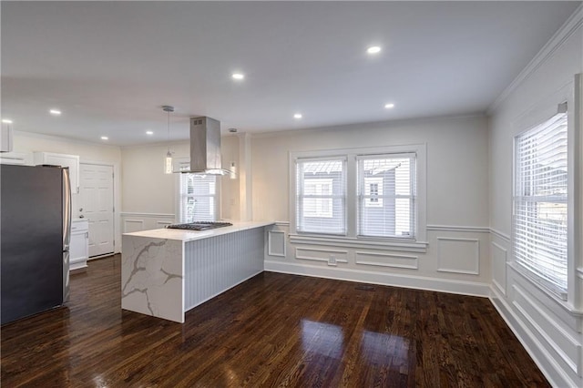 kitchen featuring ventilation hood, crown molding, a peninsula, freestanding refrigerator, and dark wood-style floors