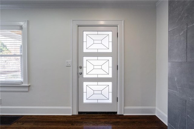 doorway with visible vents, dark wood-type flooring, baseboards, and ornamental molding