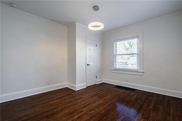 unfurnished room featuring dark wood-type flooring, visible vents, baseboards, and ornamental molding