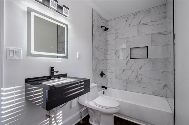 bathroom featuring toilet, washtub / shower combination, and vanity