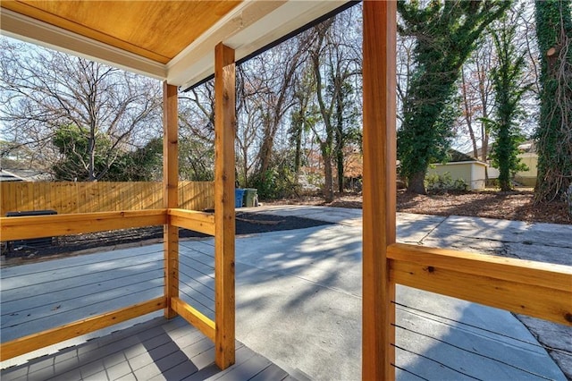 wooden deck with a patio and fence