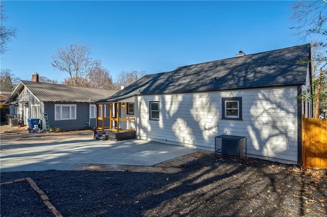 back of property featuring central AC and a patio area