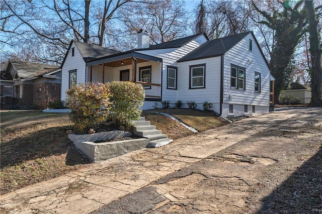 view of front of property featuring a porch and a chimney