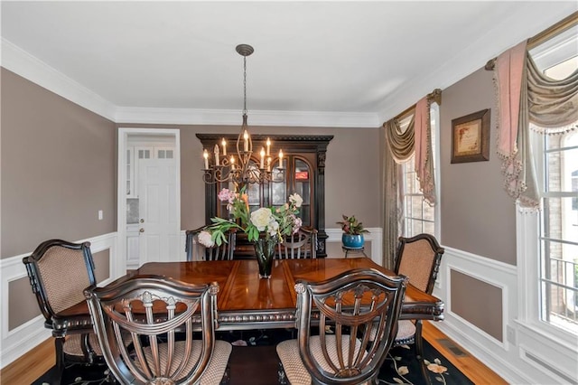 5810 Old Mill Trce, Lithonia, GA 30038 - dining space with a chandelier, a wainscoted wall, plenty of natural light, a decorative wall, and crown molding
