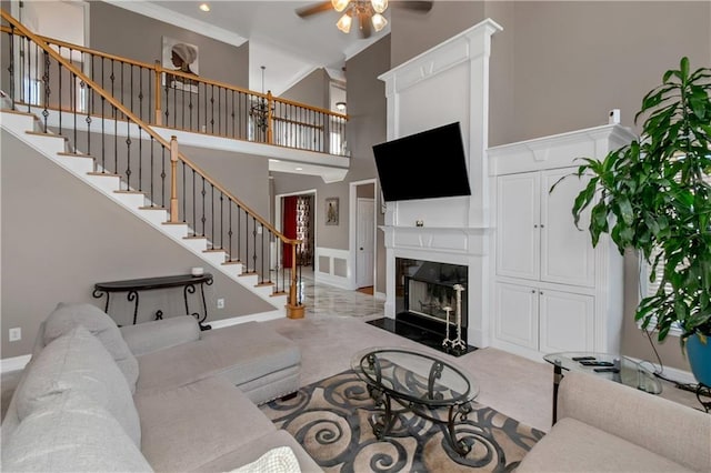 5810 Old Mill Trce, Lithonia, GA 30038 - living area with ceiling fan, stairway, a fireplace with flush hearth, a high ceiling, and baseboards