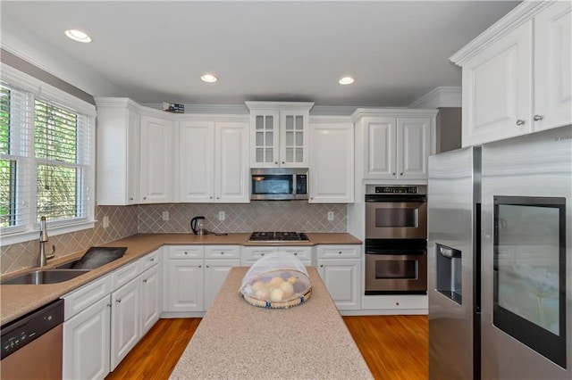 5810 Old Mill Trce, Lithonia, GA 30038 - kitchen with appliances with stainless steel finishes, a sink, white cabinets, light wood-style flooring, and recessed lighting