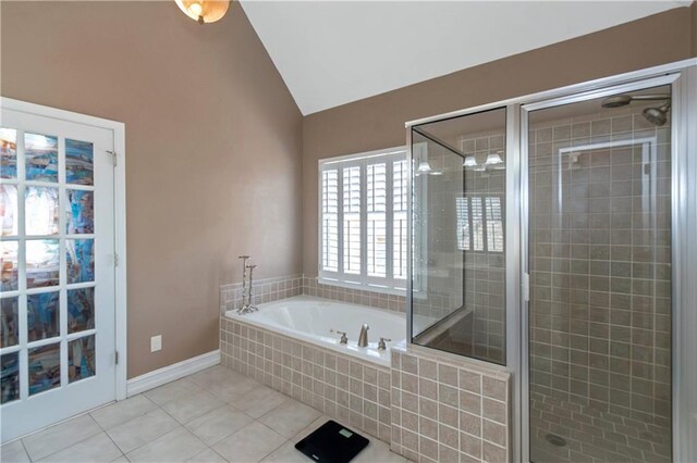 5810 Old Mill Trce, Lithonia, GA 30038 - bathroom featuring lofted ceiling, tile patterned floors, a bath, a shower stall, and baseboards