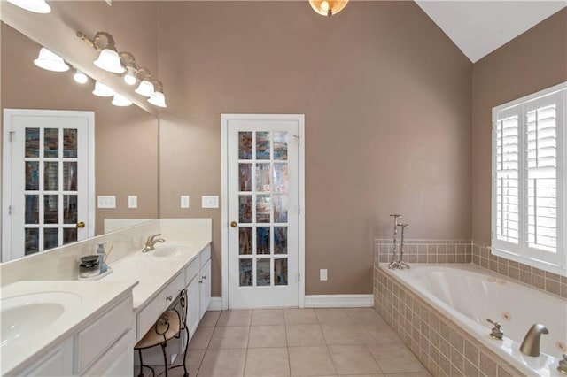 5810 Old Mill Trce, Lithonia, GA 30038 - full bath with double vanity, a whirlpool tub, healthy amount of natural light, vaulted ceiling, and tile patterned floors