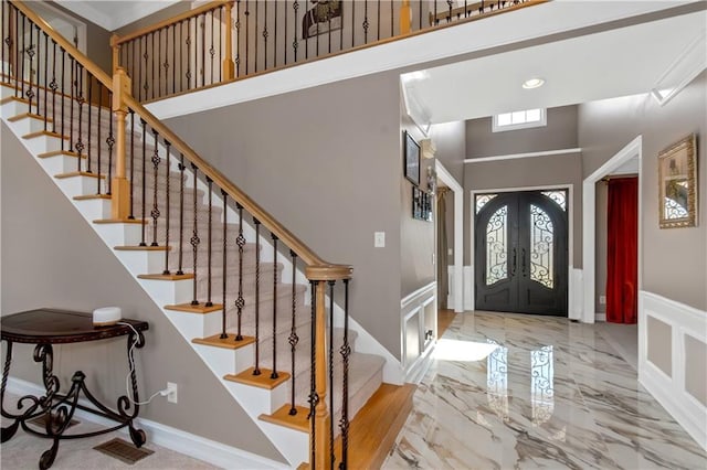 5810 Old Mill Trce, Lithonia, GA 30038 - foyer with a high ceiling, stairway, french doors, a decorative wall, and wainscoting