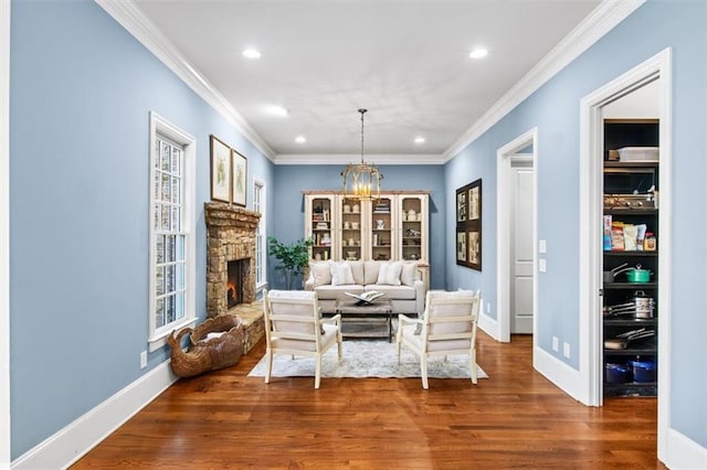 living room featuring a stone fireplace, ornamental molding, and dark hardwood / wood-style flooring