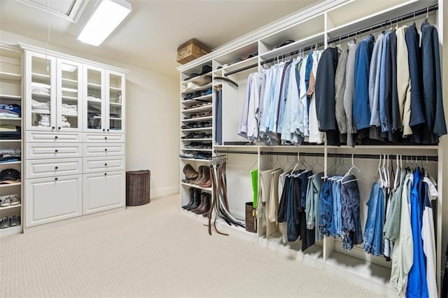 walk in closet with carpet flooring