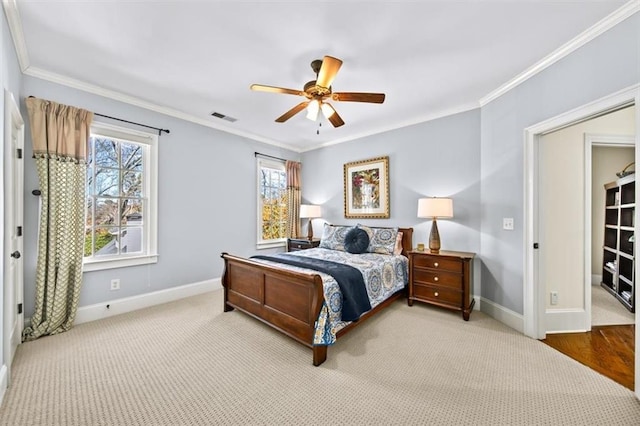 bedroom with ceiling fan, crown molding, and carpet floors