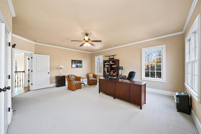 home office featuring ceiling fan, crown molding, and light carpet