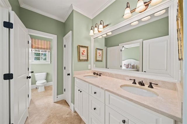 bathroom with crown molding, toilet, and vanity