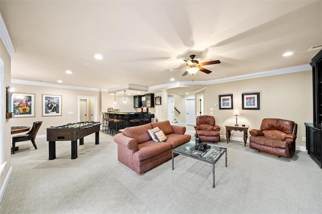 living room featuring ceiling fan, light colored carpet, and crown molding