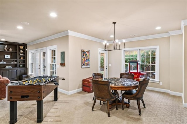 carpeted dining area featuring crown molding and an inviting chandelier