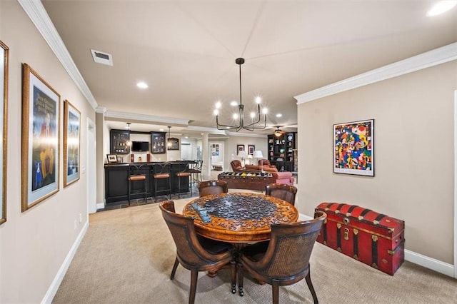 carpeted dining room featuring indoor bar and ornamental molding