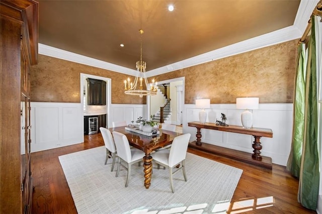 dining space featuring an inviting chandelier, dark hardwood / wood-style floors, and beverage cooler