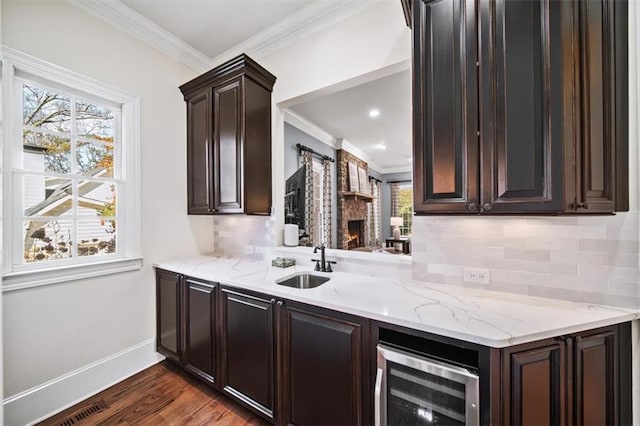 kitchen featuring sink, beverage cooler, dark hardwood / wood-style floors, and tasteful backsplash