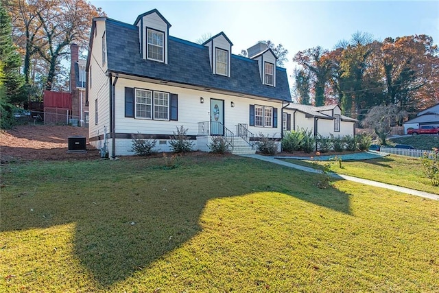 cape cod home featuring a front lawn and central air condition unit