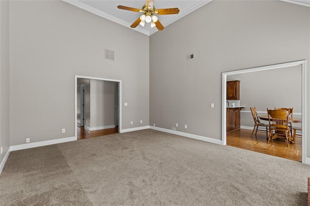 9507 Greens Mill Ct, Loganville, GA 30052 - carpeted empty room with a towering ceiling, crown molding, ceiling fan, and baseboards