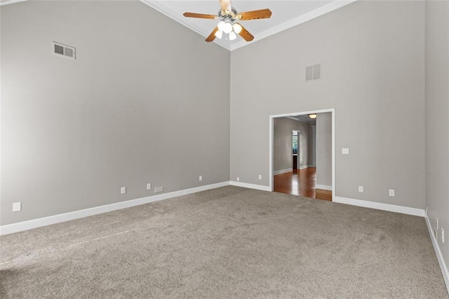 9507 Greens Mill Ct, Loganville, GA 30052 - carpeted empty room with crown molding, a ceiling fan, baseboards, and a towering ceiling