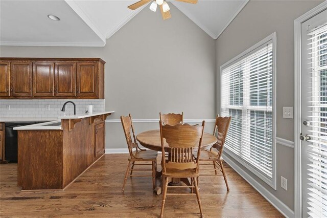 9507 Greens Mill Ct, Loganville, GA 30052 - dining area featuring lofted ceiling, crown molding, wood finished floors, ceiling fan, and baseboards