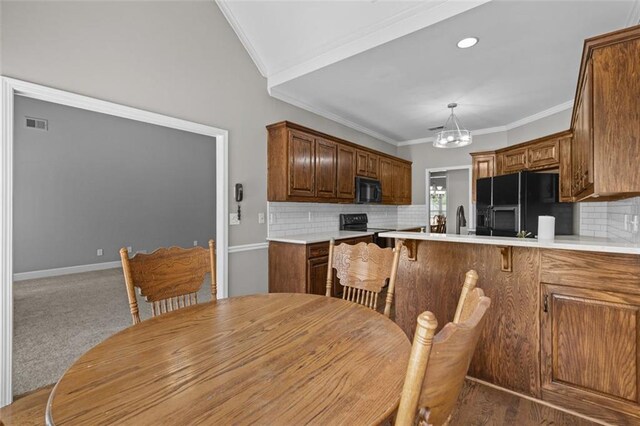 9507 Greens Mill Ct, Loganville, GA 30052 - dining area with a chandelier, ornamental molding, carpet flooring, and baseboards