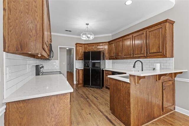 9507 Greens Mill Ct, Loganville, GA 30052 - kitchen with black refrigerator with ice dispenser, stainless steel range with electric stovetop, a peninsula, a sink, and a breakfast bar