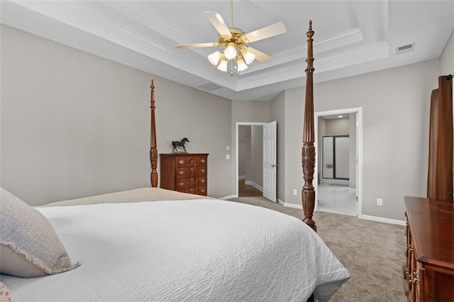 9507 Greens Mill Ct, Loganville, GA 30052 - carpeted bedroom featuring a raised ceiling, baseboards, crown molding, ceiling fan, and ensuite bathroom