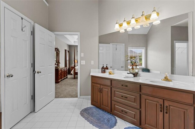 9507 Greens Mill Ct, Loganville, GA 30052 - bathroom featuring double vanity, lofted ceiling, tile patterned flooring, and connected bathroom