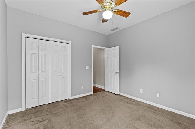 9507 Greens Mill Ct, Loganville, GA 30052 - unfurnished bedroom with carpet flooring, baseboards, a closet, and ceiling fan