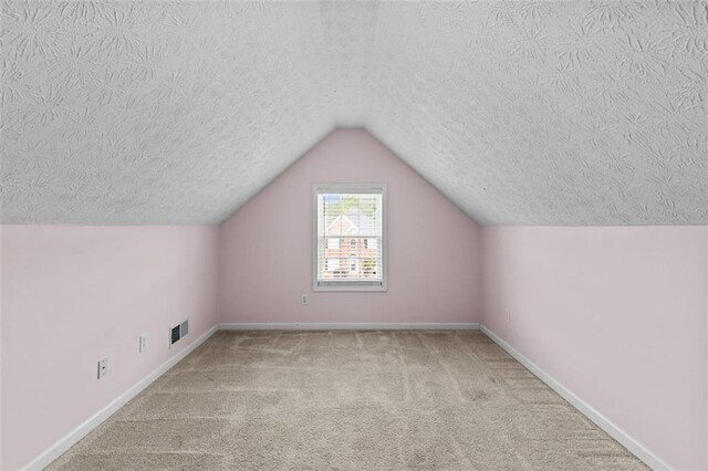 9507 Greens Mill Ct, Loganville, GA 30052 - bonus room featuring a textured ceiling, carpet floors, lofted ceiling, and baseboards