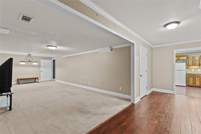 9507 Greens Mill Ct, Loganville, GA 30052 - unfurnished living room with crown molding, wood-type flooring, and baseboards