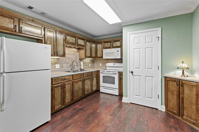 9507 Greens Mill Ct, Loganville, GA 30052 - kitchen featuring white appliances, a sink, ornamental molding, light countertops, and dark wood-type flooring