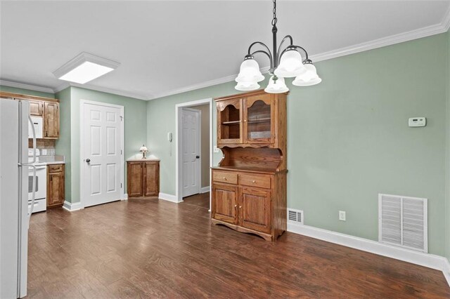 9507 Greens Mill Ct, Loganville, GA 30052 - dining room with a chandelier, ornamental molding, dark wood-style floors, and baseboards