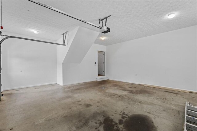 9507 Greens Mill Ct, Loganville, GA 30052 - garage featuring a garage door opener and baseboards