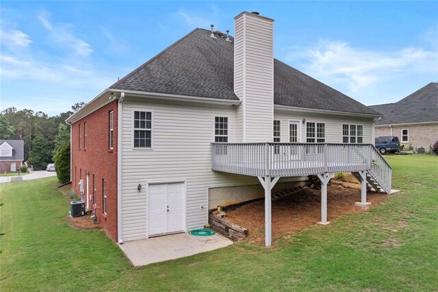 9507 Greens Mill Ct, Loganville, GA 30052 - back of property with a chimney, a wooden deck, a yard, and roof with shingles