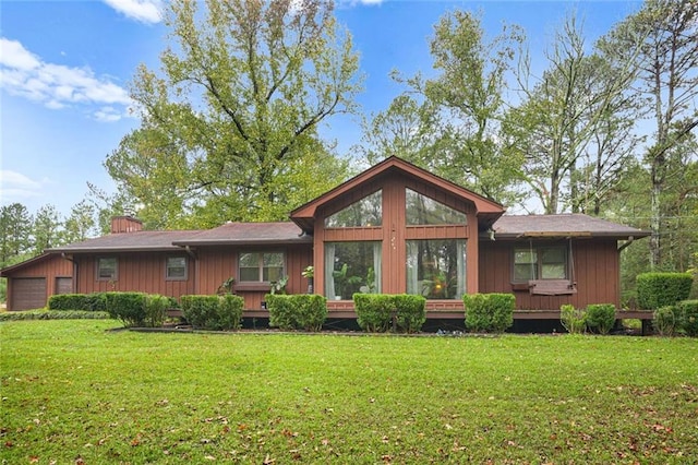 back of property featuring a lawn