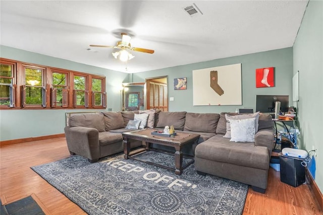 living room featuring ceiling fan and hardwood / wood-style floors