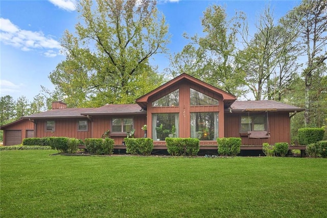 rear view of house with a lawn