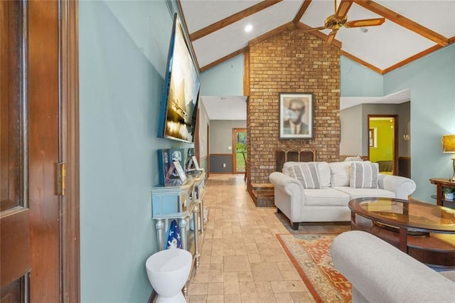 living room featuring ceiling fan, vaulted ceiling with beams, and a fireplace