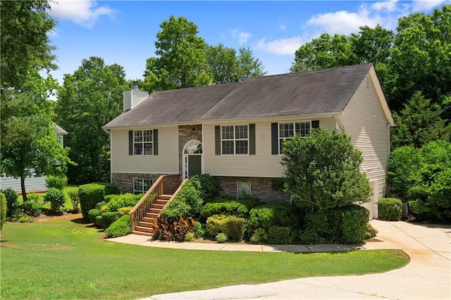 90 Cypress Dr, Covington, GA 30016 - raised ranch featuring a chimney, a front lawn, stone siding, driveway, and stairway