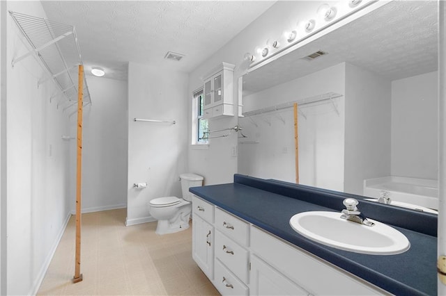 90 Cypress Dr, Covington, GA 30016 - full bath with vanity, a textured ceiling, toilet, a bath, and baseboards